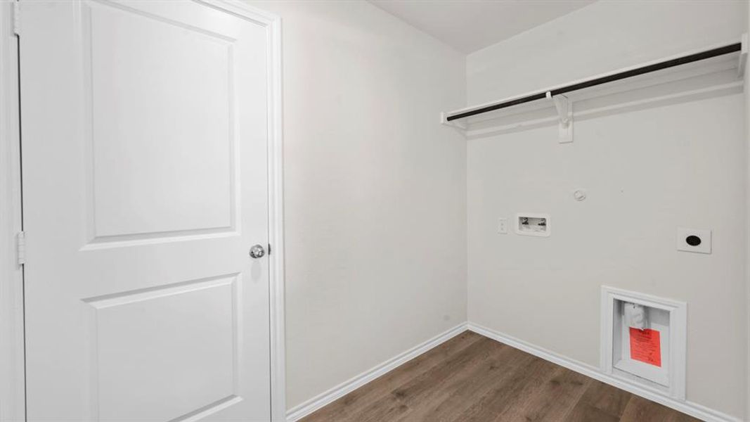 Laundry room featuring washer hookup, dark wood-type flooring, hookup for an electric dryer, and gas dryer hookup