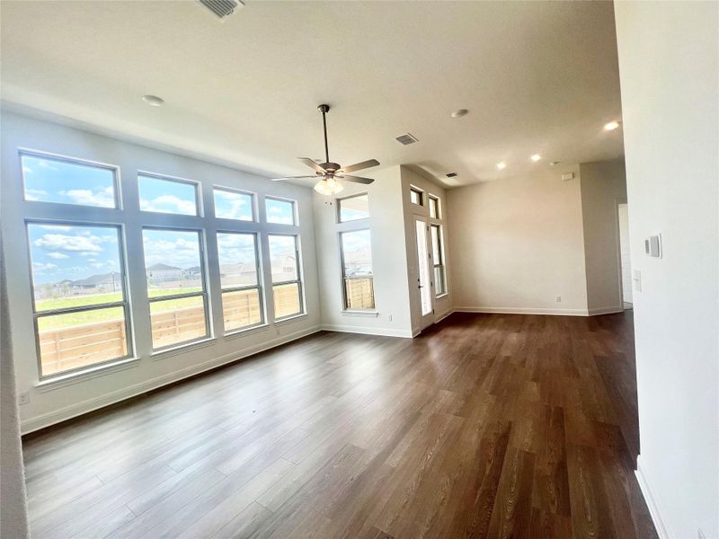 Unfurnished living room featuring recessed lighting, dark wood-style floors, and a ceiling fan Unfurnished living room featuring recessed lighting, dark wood-style floors, and a ceiling fan