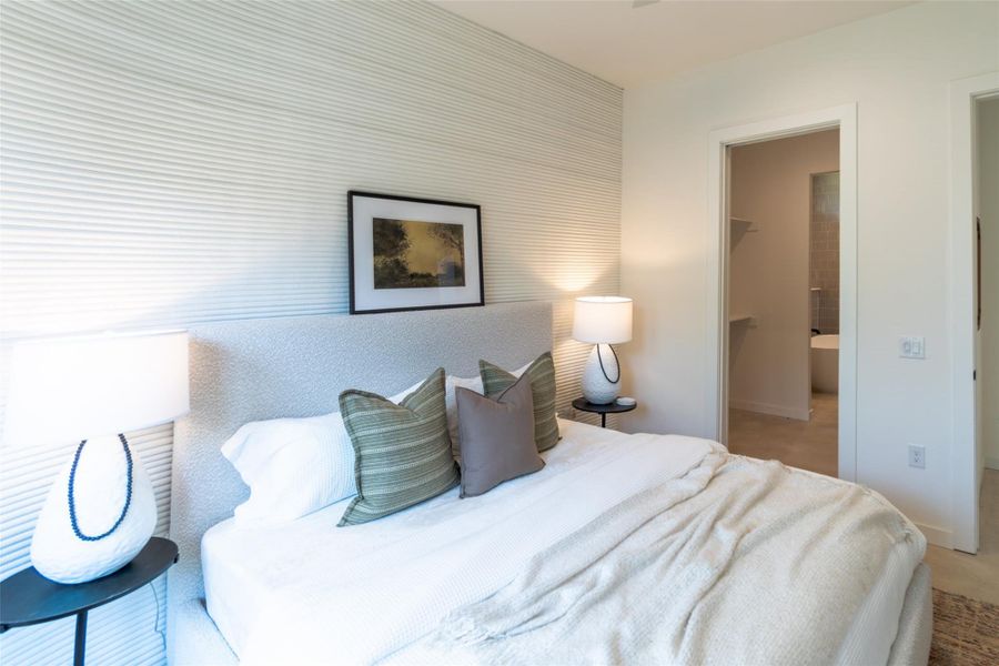 Bedroom featuring a spacious closet and baseboards Bedroom featuring a spacious closet and baseboards