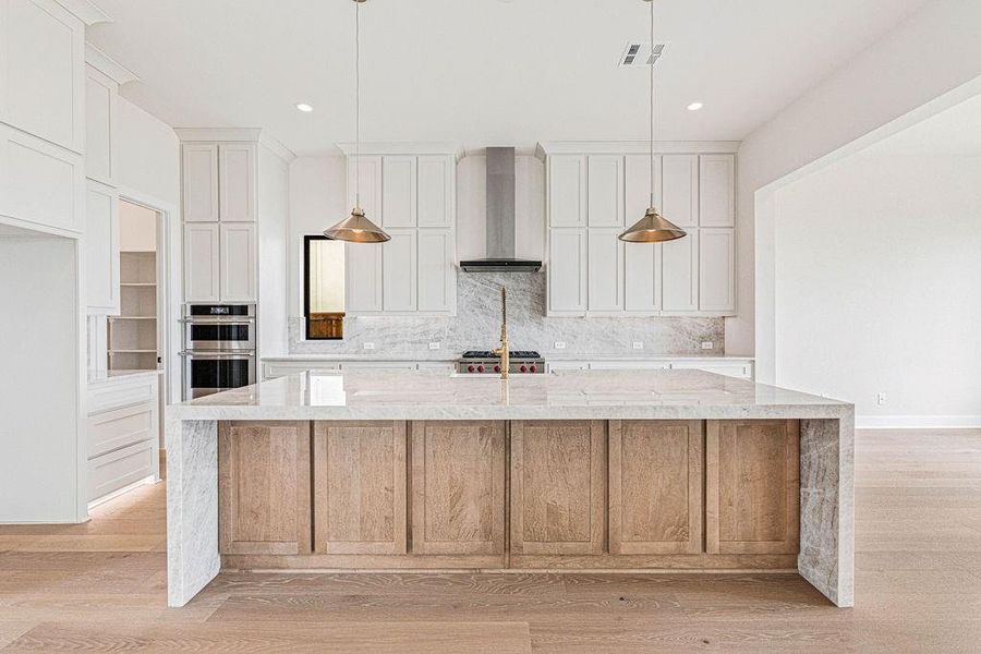 Gorgeous Taj Mahal quartzite countertops island with waterfall sides and backsplash