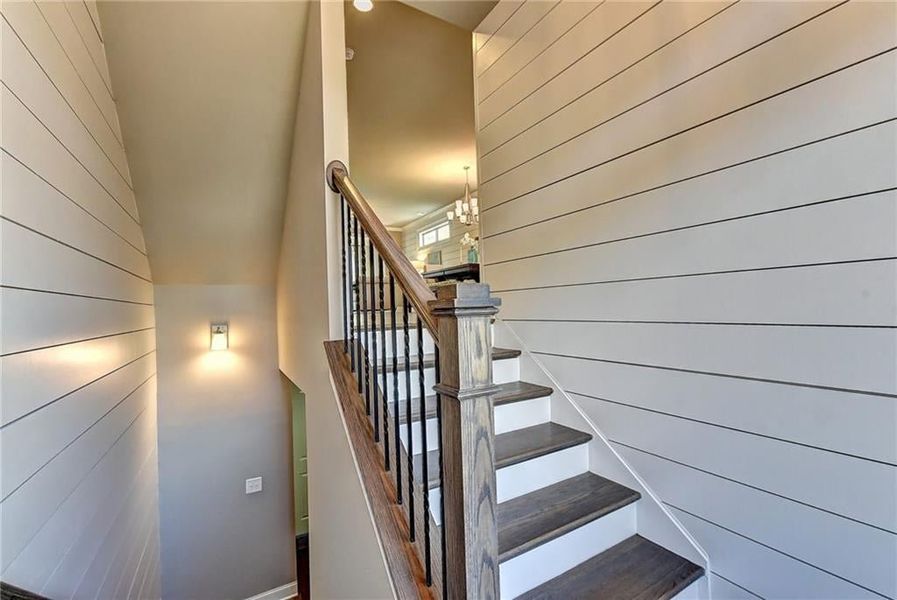 Stairs with a high ceiling   ***Photos NOT OF ACTUAL Home but for representation Purposes only. Home is UNDER Construction- Photos are of a previously built Model House Freemont plan by The Providence Group