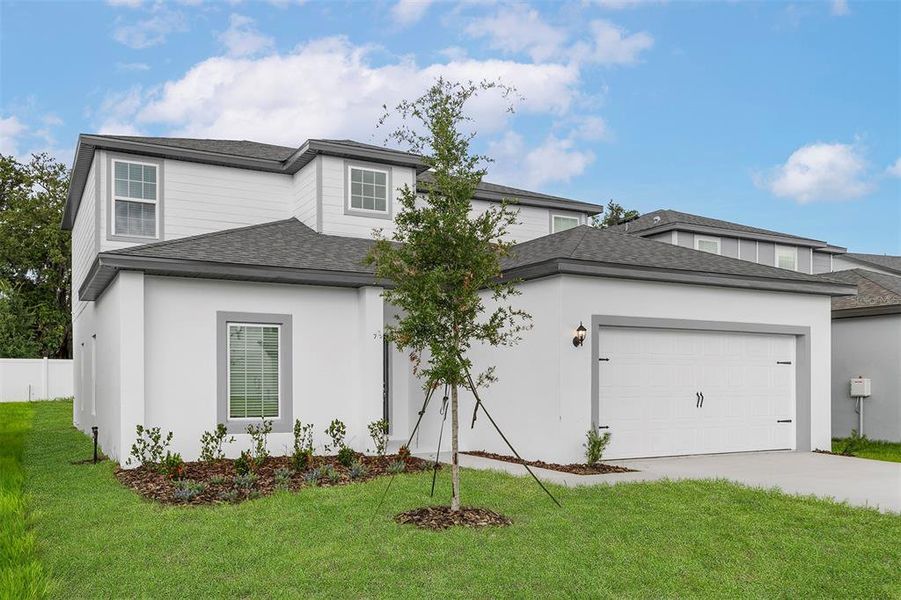 Front exterior of a new home in Tula Parc, Astatula, FL, highlighting curb appeal (Image 27).