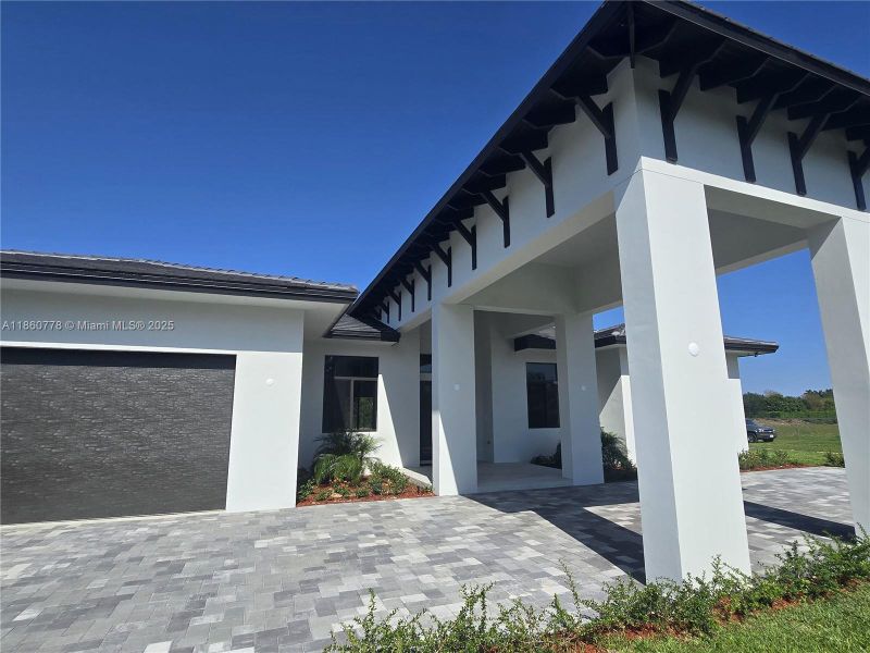 Front exterior of a new home in , Homestead, FL, highlighting curb appeal (Image 25).