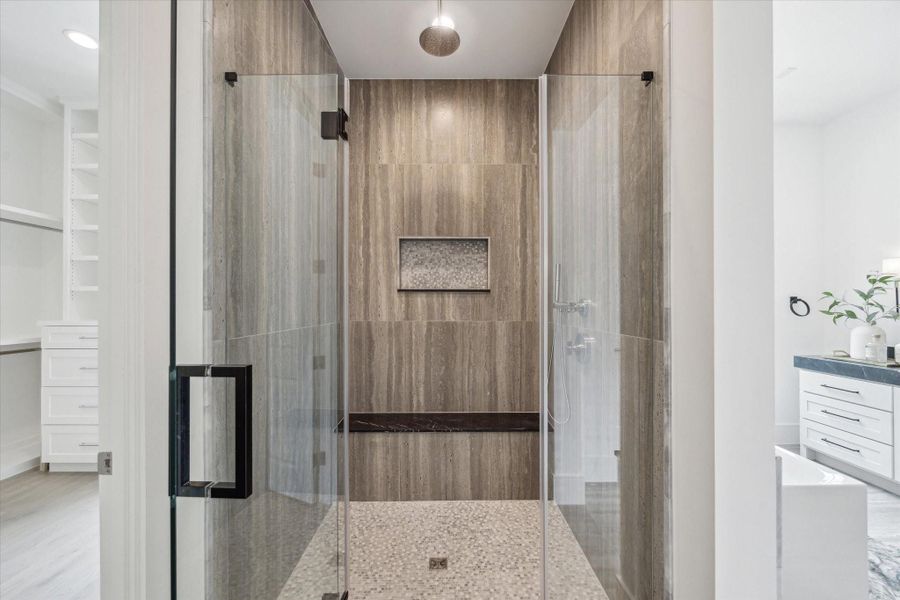 Framed glass shower with mosaic floor and niche design and Nero Marquina Marble bench create a cohesive space. Framed glass shower with mosaic floor and niche design and Nero Marquina Marble bench create a cohesive space.