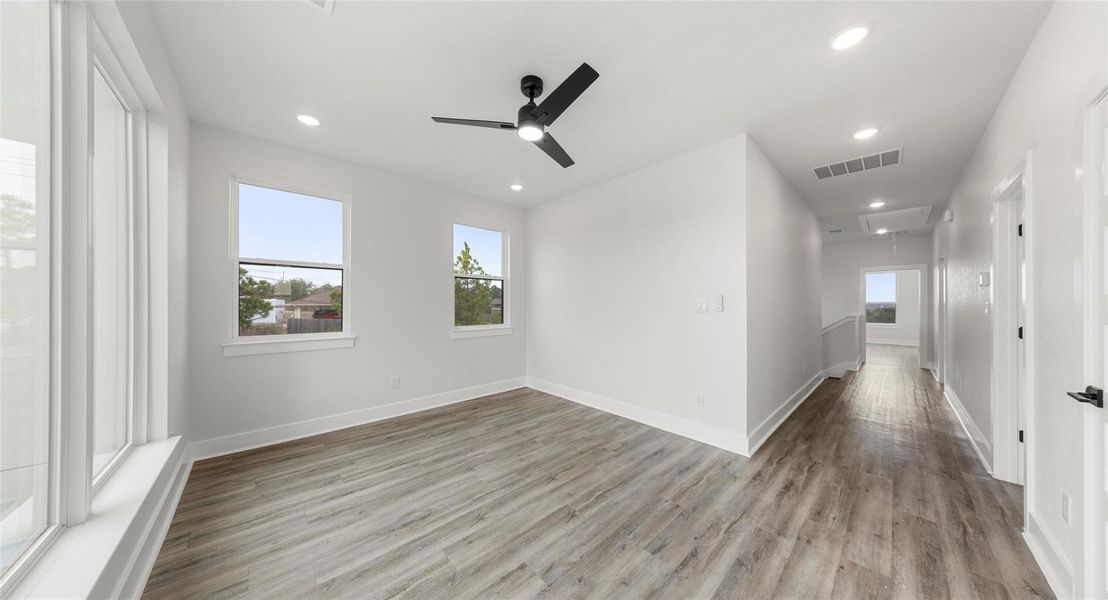 Spare room featuring attic access, recessed lighting, light wood-type flooring, and ceiling fan
