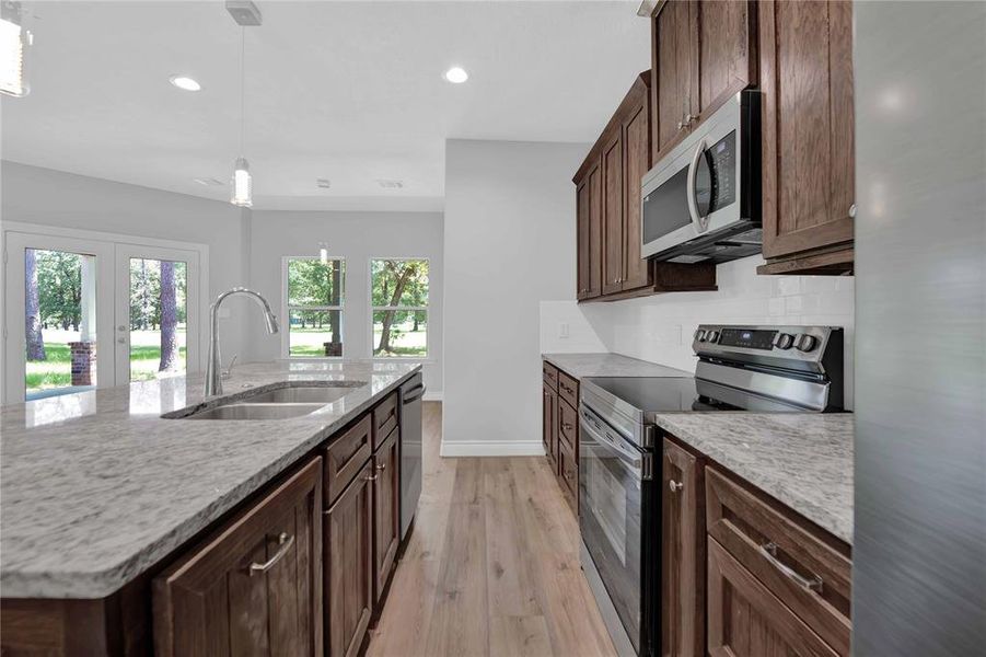 Galley style kitchen with granite counters is very functional!