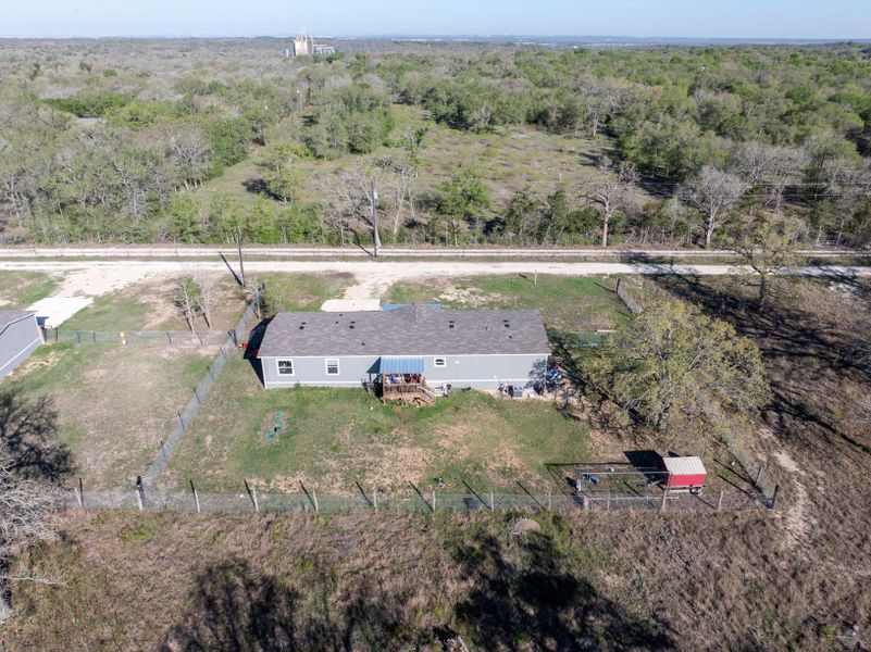 Aerial view of property and surrounding area featuring a heavily wooded area Aerial view of property and surrounding area featuring a heavily wooded area