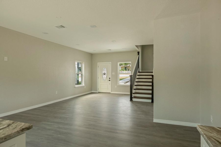 Entryway featuring stairway and dark wood-style flooring