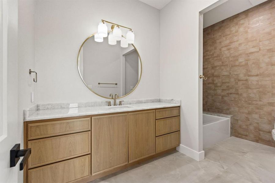 Full bathroom featuring vanity, shower / bathtub
combination, and light tile patterned floors Full bathroom featuring vanity, shower / bathtub
combination, and light tile patterned floors