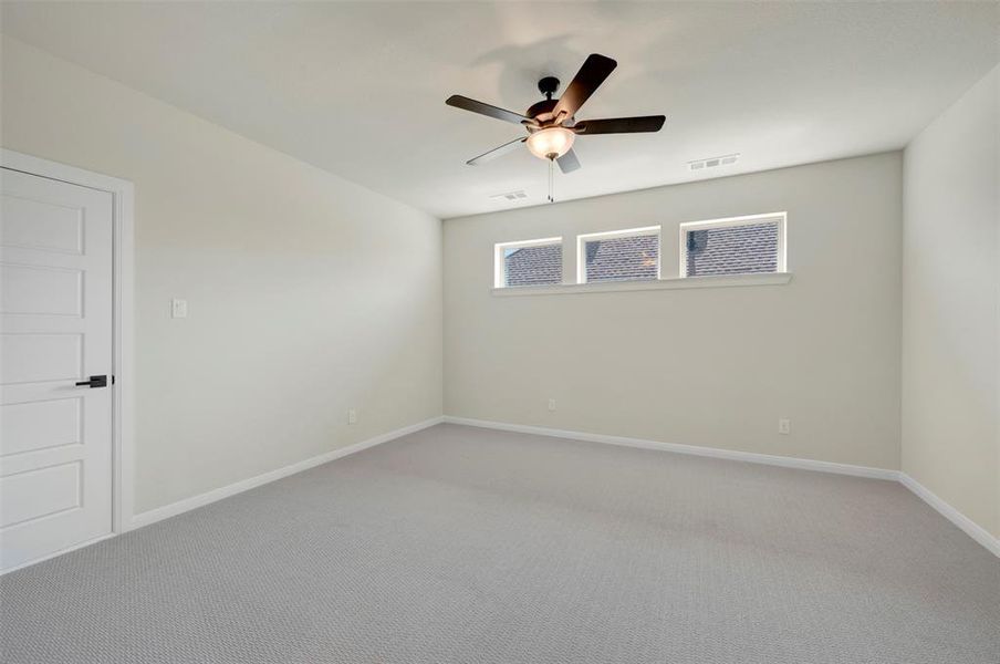 Unfurnished room featuring carpet and a ceiling fan