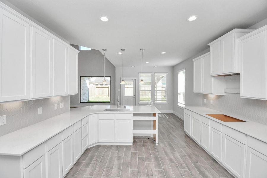 The open concept effortlessly connects the kitchen to the expansive family room, forming a perfect hub for gatherings. This seamless flow creates an inviting space where cooking and socializing come together harmoniously.