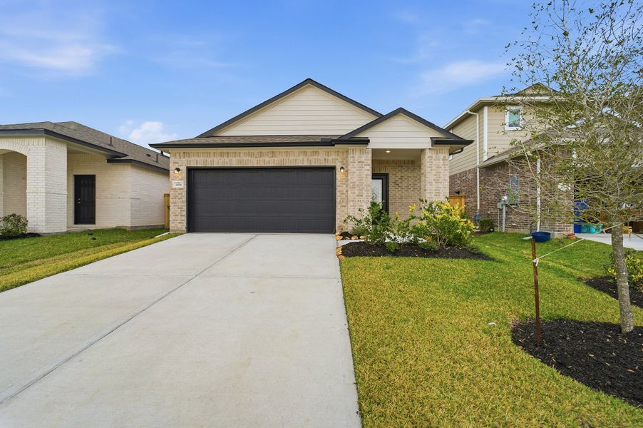 Front exterior of a new home in Windrose Green, Angleton, TX, highlighting curb appeal (Image 2).