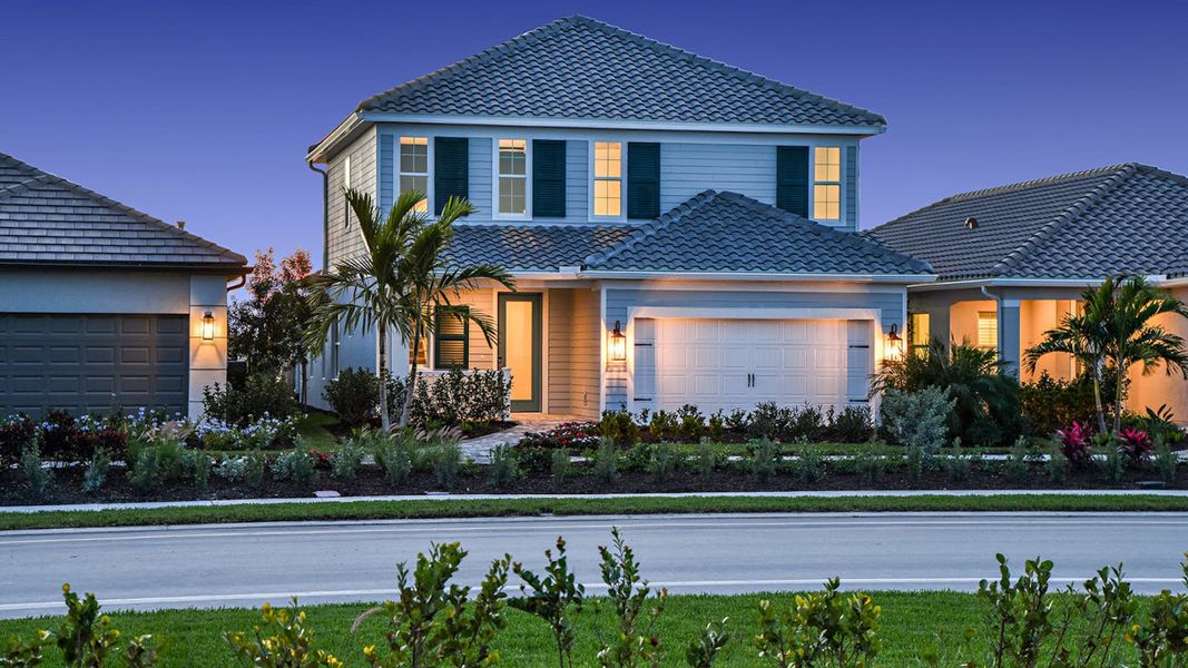 Front exterior of a new home in SkySail Real Estate and Homes for Sale in Naples, FL - Neal Communities, Naples, FL, highlighting curb appeal (Image 19).