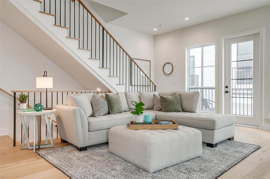 Living area featuring light wood-type flooring, recessed lighting, and stairway Living area featuring light wood-type flooring, recessed lighting, and stairway