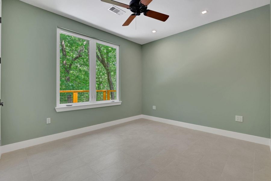 Spacious second guest bedroom overlooking the back of the property for peaceful forest views