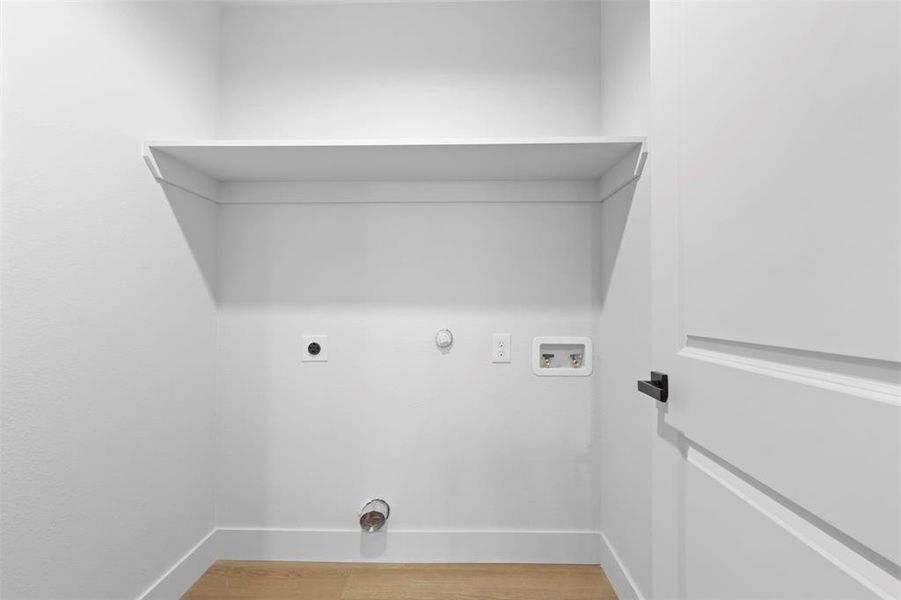 Laundry area with electric dryer hookup, washer hookup, hardwood / wood-style floors, and hookup for a gas dryer