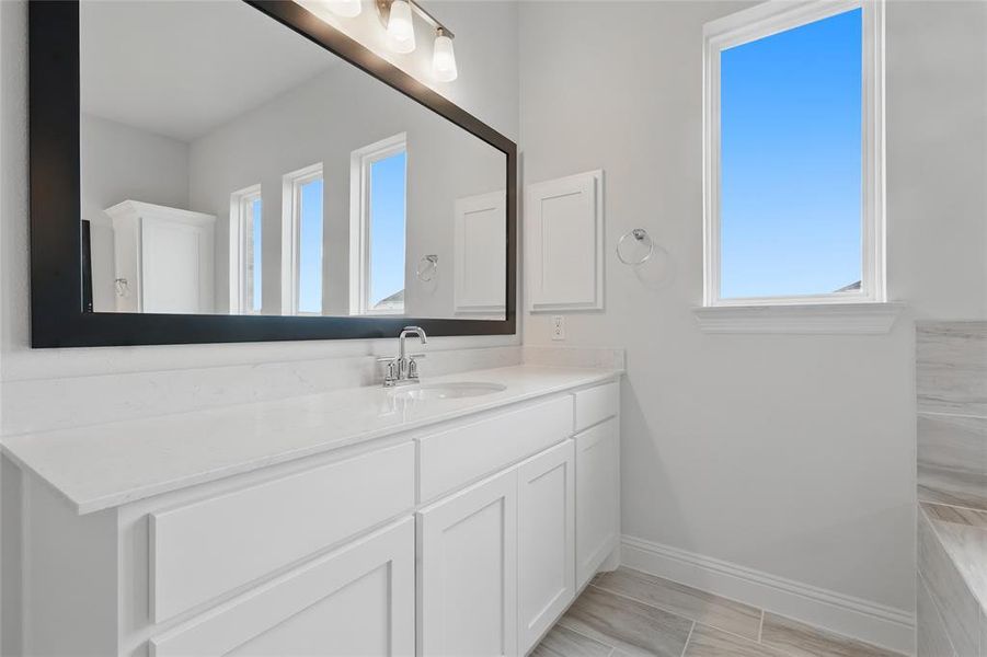 Bathroom with baseboards and vanity