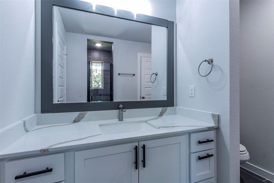 Bathroom featuring vanity and toilet