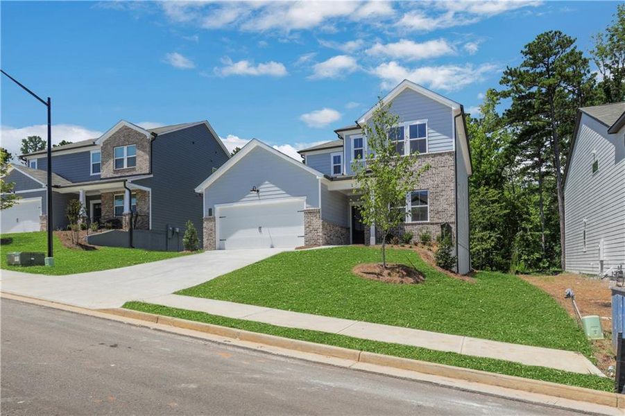 Front exterior of a new home in Cambridge at Steels Bridge, Canton, GA, highlighting curb appeal (Image 15).