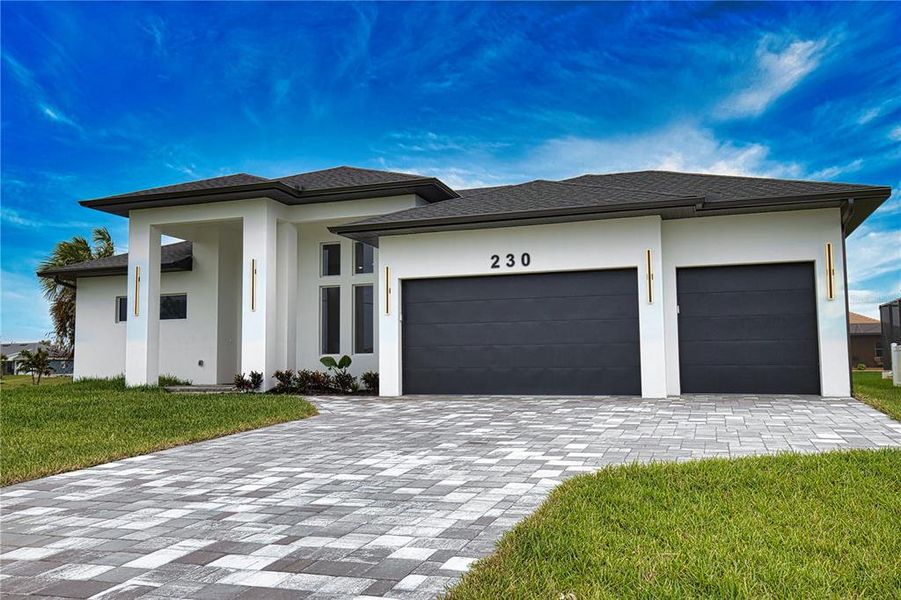 the driveway is with cement and turf lines, creating a modern look the driveway is with cement and turf lines, creating a modern look