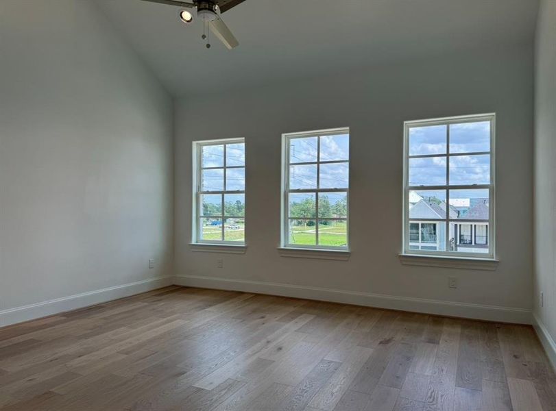 Vaulted Ceilings in Primary Bedroom with Wide Plank Wood Floors