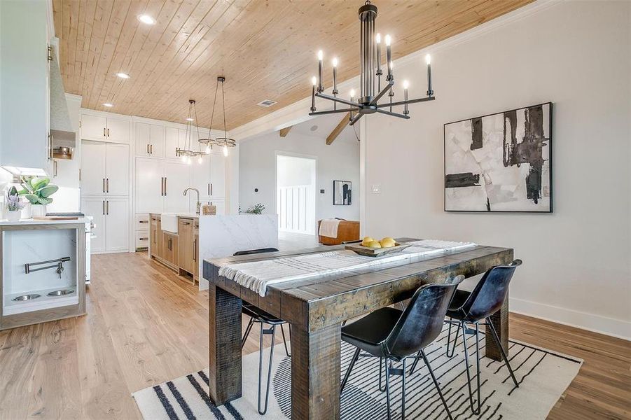 Dining room featuring wood ceiling, light wood-type flooring, recessed lighting, and a chandelier