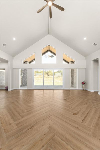 Unfurnished living room featuring high vaulted ceiling, recessed lighting, and ceiling fan