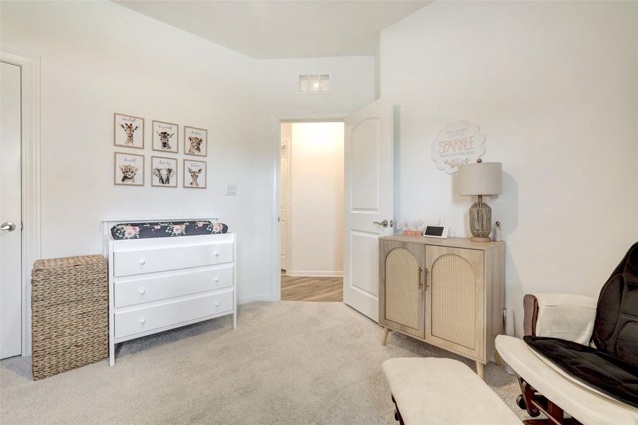 Sitting room featuring carpet floors and baseboards