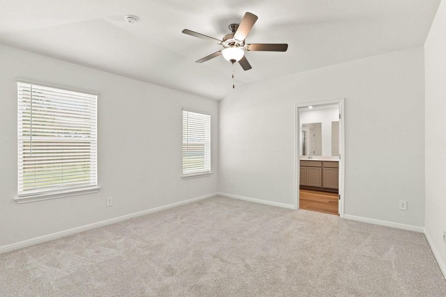 Plush carpeting and vaulted ceilings define this peaceful bedroom retreat.