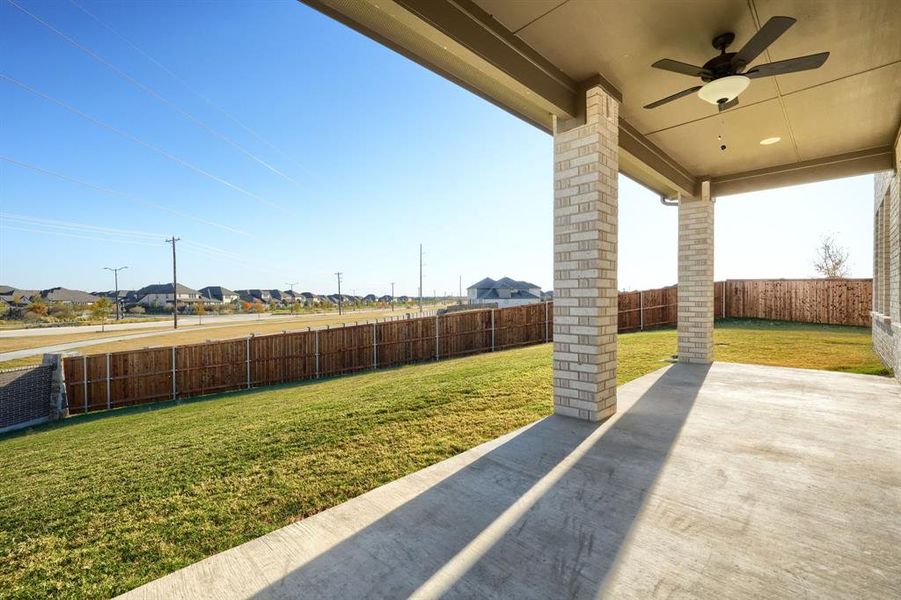 Fenced backyard featuring a patio, a ceiling fan, and a residential view Fenced backyard featuring a patio, a ceiling fan, and a residential view