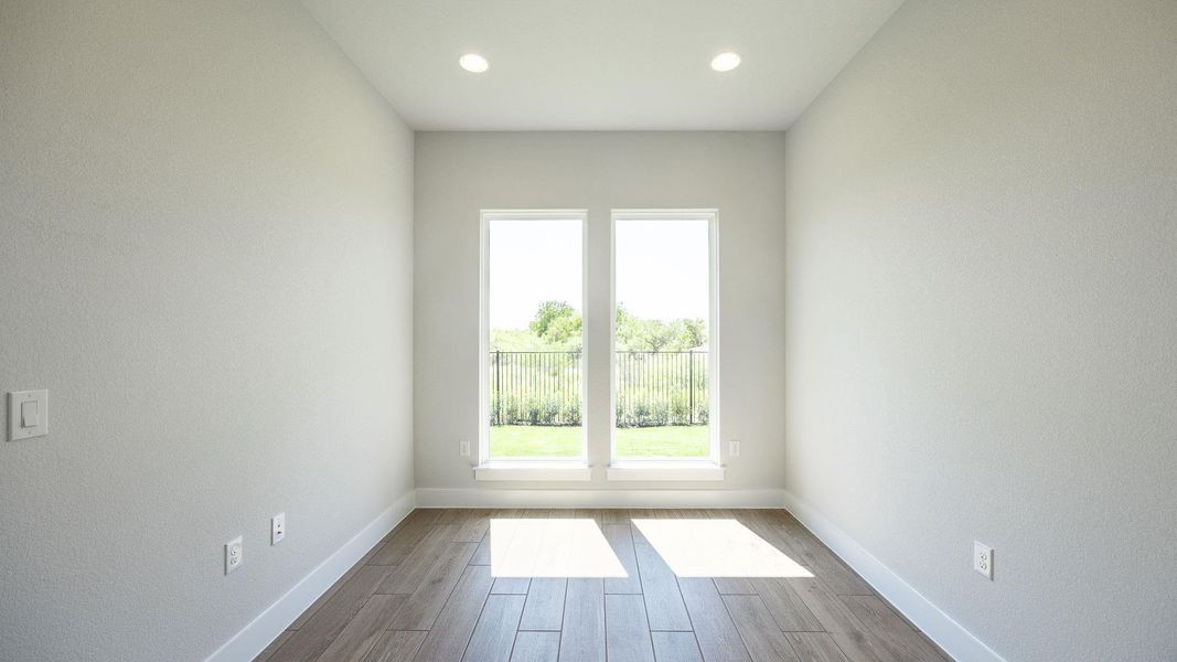 Unfurnished room with wood finished floors and recessed lighting