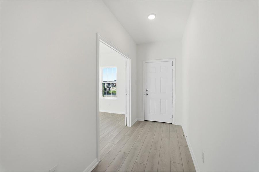 Entry foyer featuring wood-finish flooring, recessed lighting, and a paneled entry door