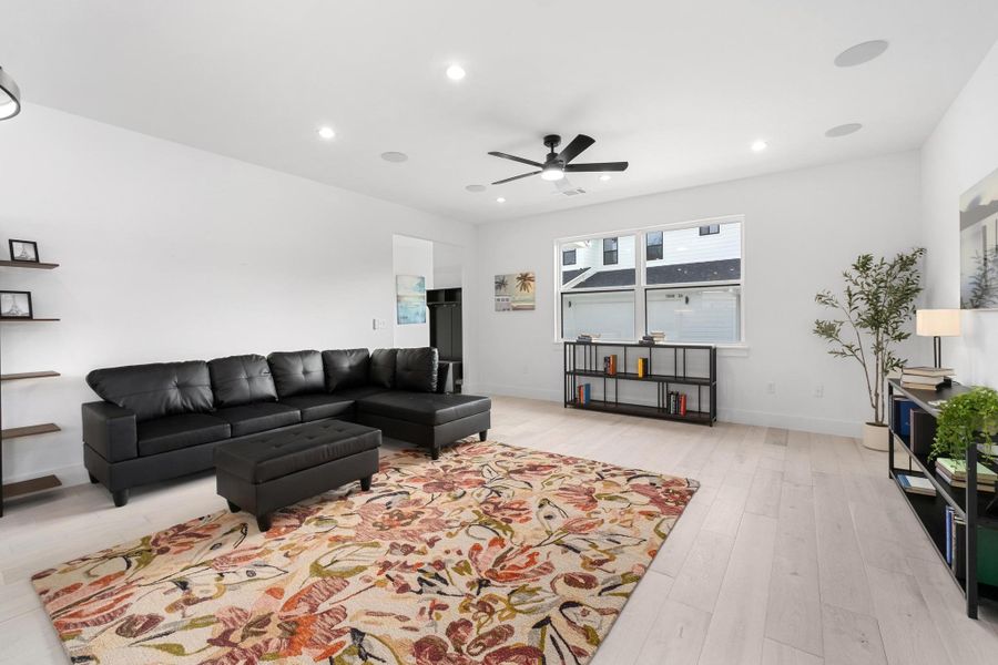 Living area featuring recessed lighting, a ceiling fan, and light wood-style flooring