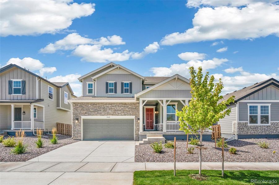 Front exterior of a new home in Turnberry, Commerce City, CO, highlighting curb appeal (Image 1).