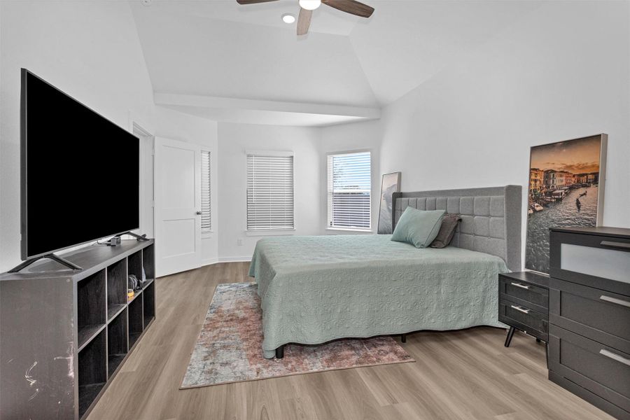 This alternate view of the primary bedroom highlights the beautiful bay windows, which fill the space with natural light and enhance the room’s open, airy feel.