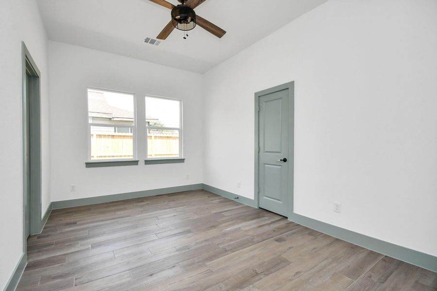 Bedroom 3 with a ceiling fan and plenty of closet space.