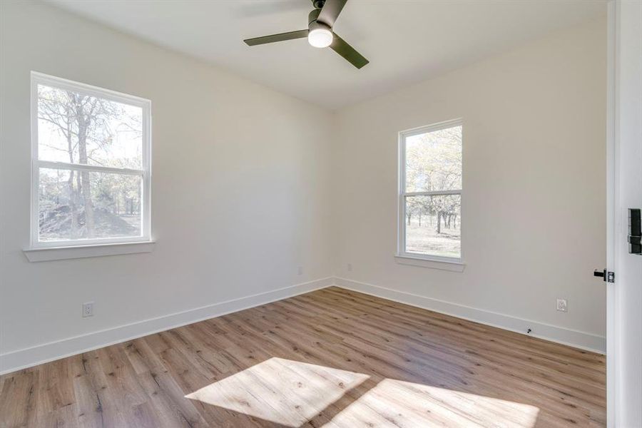 Spare room featuring ceiling fan and light hardwood / wood-style flooring