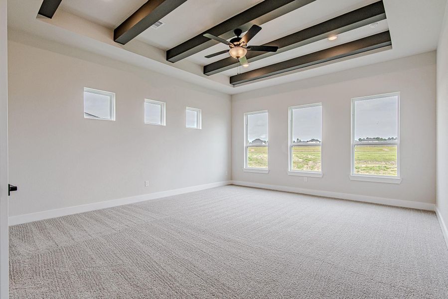 Spacious room with exposed beam ceilings and plenty of natural light.