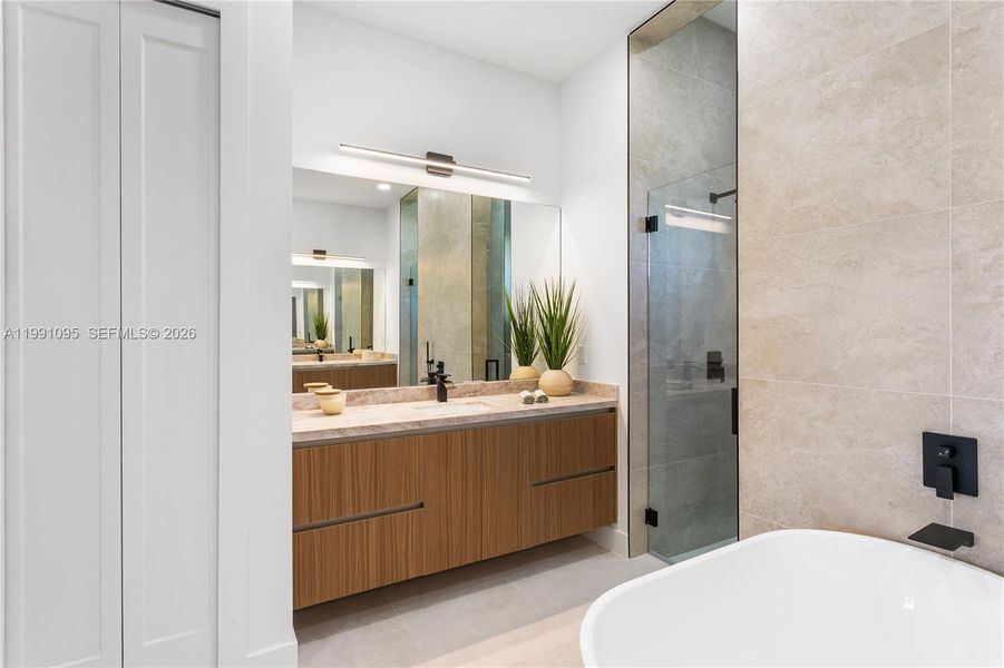 Primary spa bathroom with stand-alone tub, dual sinks, floating cabinetry and marble countertops! Primary spa bathroom with stand-alone tub, dual sinks, floating cabinetry and marble countertops!