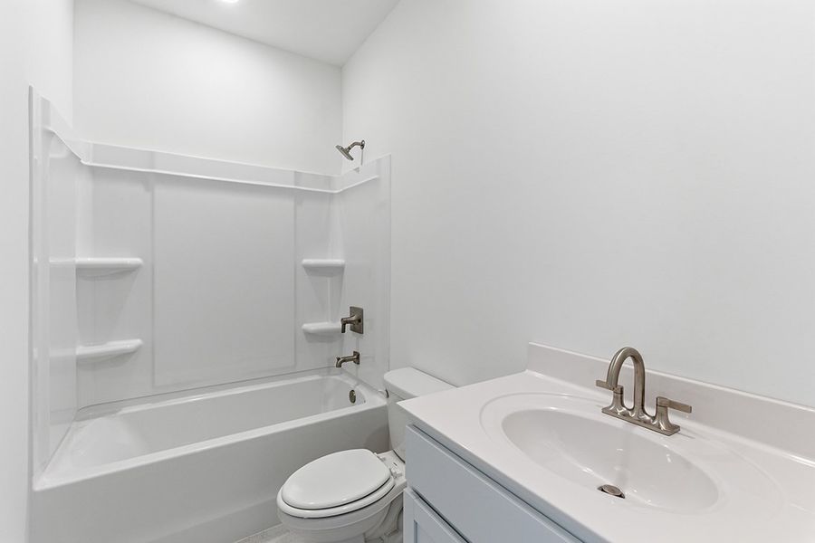 A bathroom with a sink toilet and bathtub.