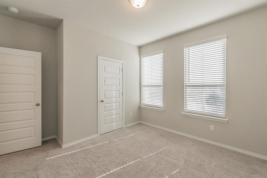 Unfurnished bedroom featuring carpet flooring and a closet