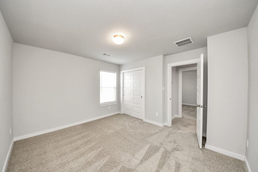 Generously sized secondary bedrooms featuring spacious closets, soft and inviting carpeting underfoot, large windows allowing plenty of natural light, and the added touch of privacy blinds for your personal retreat. Sample photo of completed home with similar floor plan. Actual colors and selections may vary. Generously sized secondary bedrooms featuring spacious closets, soft and inviting carpeting underfoot, large windows allowing plenty of natural light, and the added touch of privacy blinds for your personal retreat. Sample photo of completed home with similar floor plan. Actual colors and selections may vary.