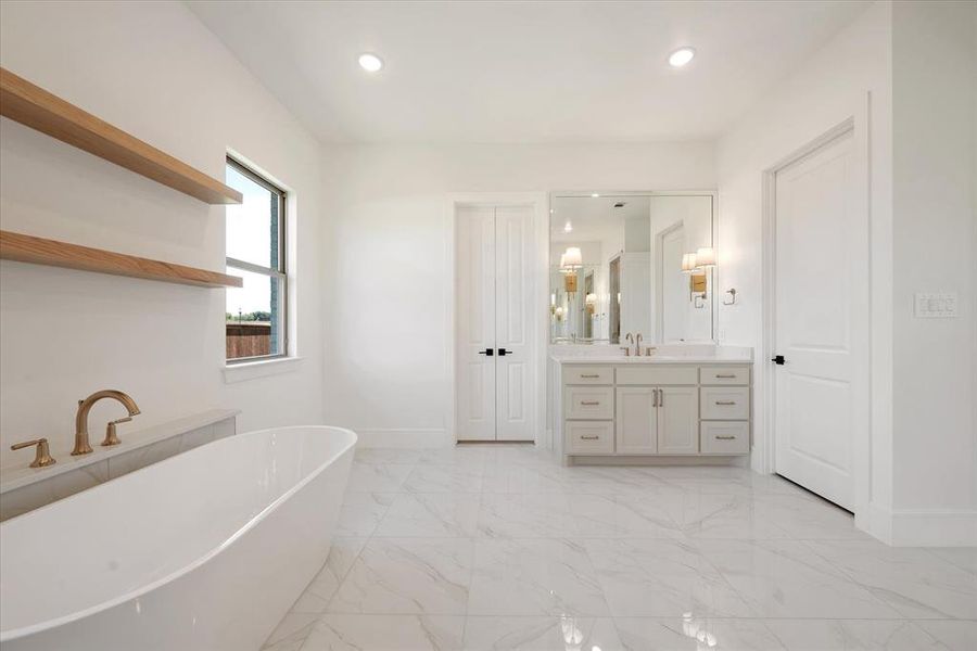 Bathroom featuring a bathtub and vanity