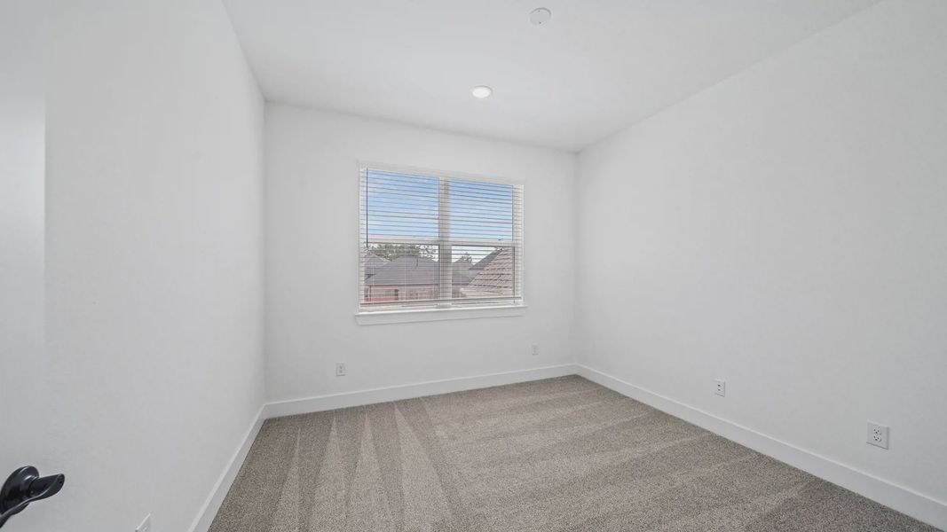 Representative unfurnished interior of a home built from the Waterloo by Chesmar Homes in Sofi Lakes, Katy (Image 40).