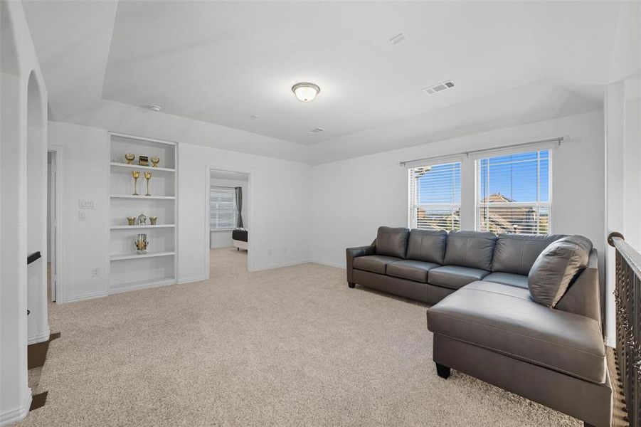 2nd floor Living room featuring light carpet and built in shelves 2nd floor Living room featuring light carpet and built in shelves