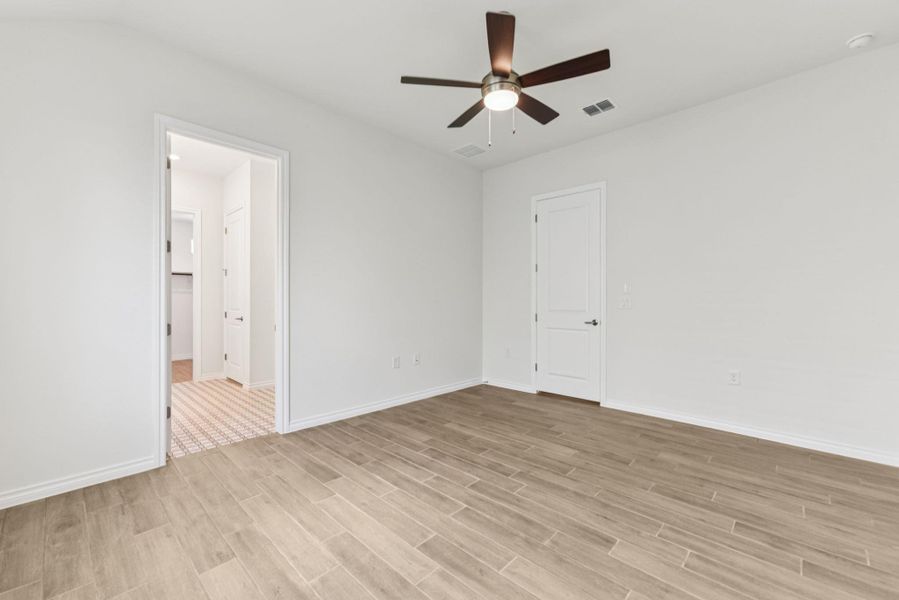 Unfurnished room featuring light wood finished floors and a ceiling fan Unfurnished room featuring light wood finished floors and a ceiling fan