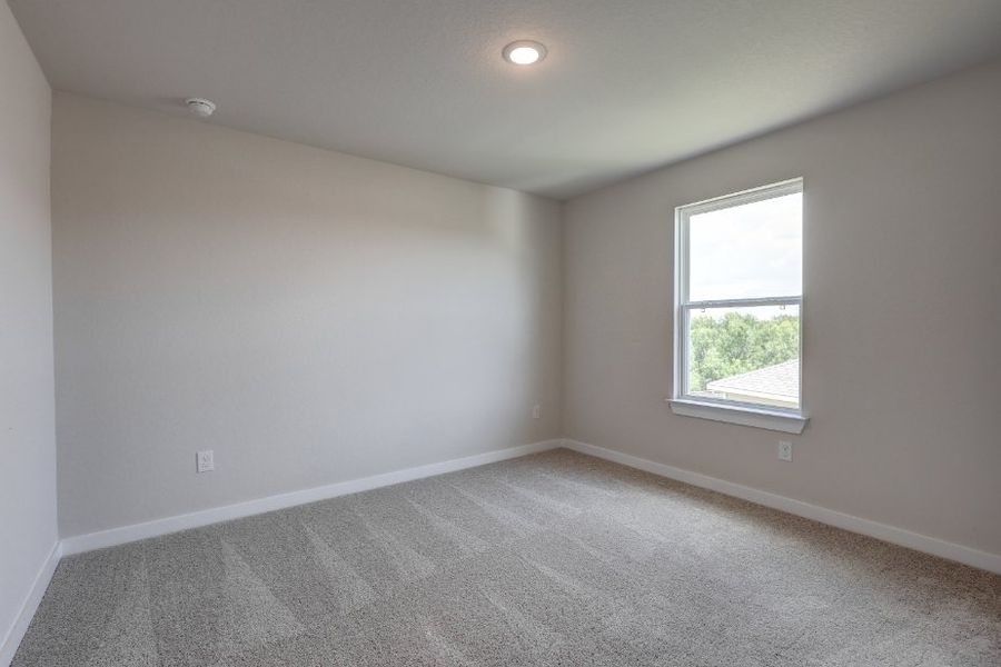 A room with a window and a carpet.