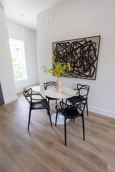 Dining area with hardwood / wood-style flooring