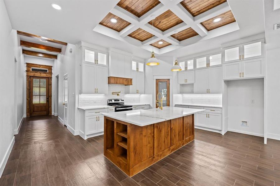Kitchen featuring glass insert cabinets, decorative backsplash, white cabinetry, decorative light fixtures, and coffered ceiling Kitchen featuring glass insert cabinets, decorative backsplash, white cabinetry, decorative light fixtures, and coffered ceiling