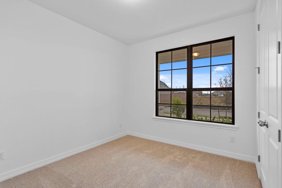 This secondary bedroom offers a serene space grounded in classic style. This secondary bedroom offers a serene space grounded in classic style.